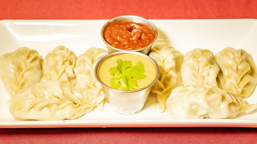 Steam Chicken Momo · Minced chicken wrapped in pastry served with tomato and sesame seed achar