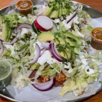 Tinga Tostadas · Tinga = Shredded chicken cooked with onions.
Three per order, lettuce, avocado, onions, sals...