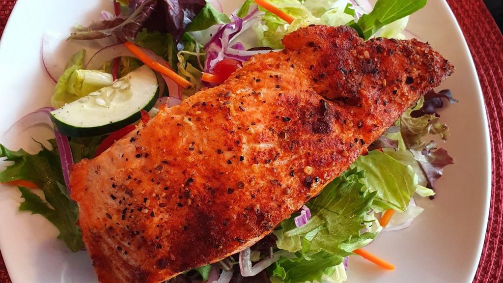 Grilled Salmon Fillet Salad · 8-ounce Grilled fillet of salmon on top of mixed greens, romaine lettuce, tomatoes, cucumbers, and red onions, carrots and red cabbage.