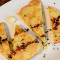 Tortilla Espanola · Spanish potato omelet, garlic aioli, balsamic reduction.