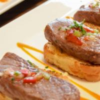 Beef Medallions · Served with toasted bread and Tablao vinaigrette.