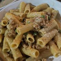 Rigatoni Alla Buttera · Crumbled sausage, green peas in a pink sauce and topped with fresh grated Parmesan cheese.