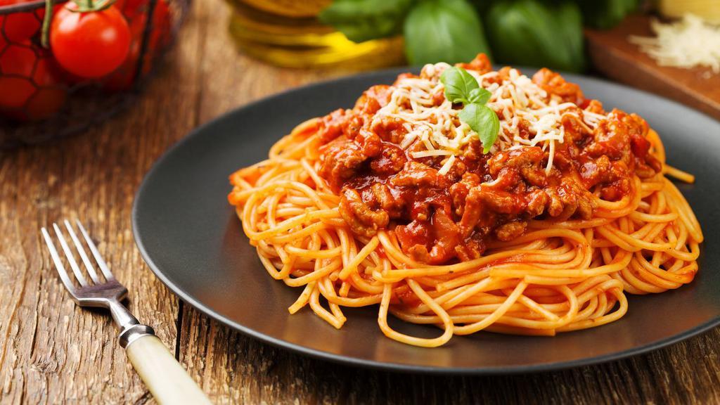 The Beef Bolognese Pasta · Ground beef cooked in spicy marinara sauce and sitting on a bed of pasta.