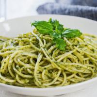 The Pesto Pasta · Fresh basil leaves, garlic, grated parmesan sitting on a bed of pasta.