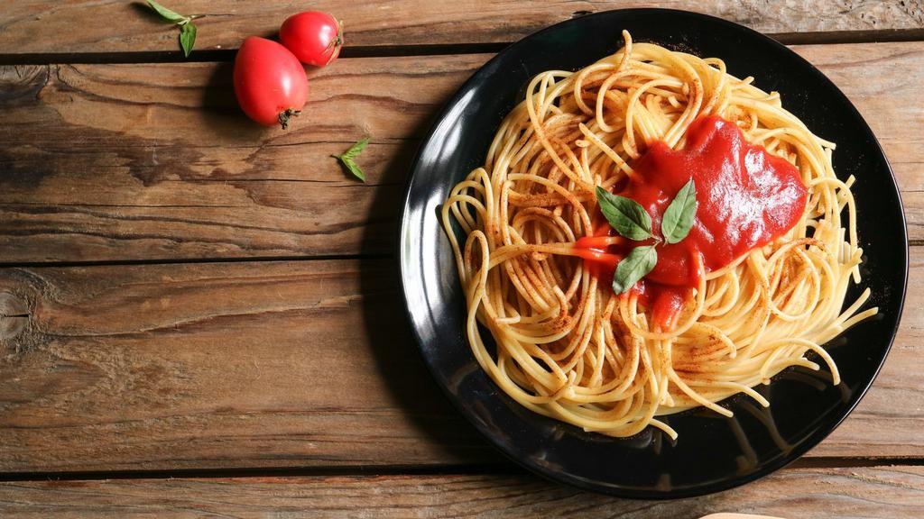 The Marinara · Fresh tomatoes, olive oil, basil, and  homemade marinara sauce sitting on a bed of pasta.