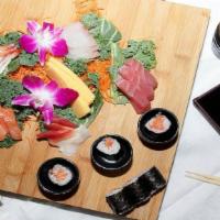 Sashimi Deluxe · 18 pieces of assorted raw fish with white rice on the side. Served with miso soup or green s...