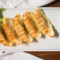 Gyoza · Pan-fried dumplings filled with ground pork and vegetables.
