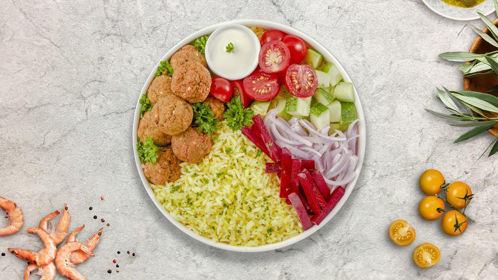 Falafel Combo On Rice · Crispy falafel balls with your choice of gyro meat served on a sizzling bed of rice, lettuce on the side, and drizzled with our chef's exquisite white and red sauce.