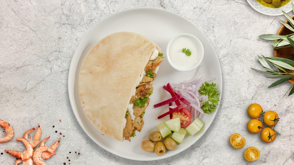 Chicken Gyro On Pita · Thinly sliced pieces of chicken marinated in a mediterranean blend of herbs and spices with mixed veggies and our chef's exquisite white and red sauce served in a pita pocket.