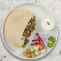 Lamb Gyro On Pita · Thinly sliced pieces of lamb gyro meat marinated in a mediterranean blend of herbs and spice...