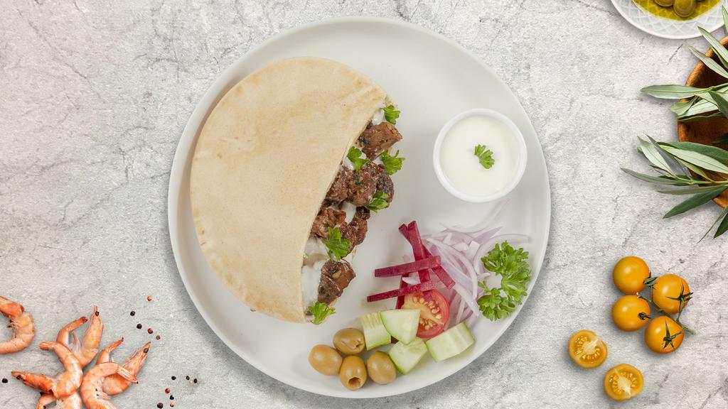 Lamb Gyro On Pita · Thinly sliced pieces of lamb gyro meat marinated in a mediterranean blend of herbs and spices with mixed veggies and our chef's exquisite white and red sauce served in a pita pocket.