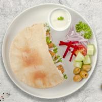 Falafel Combo On Pita · Crispy falafel balls with your choice of gyro meat with mixed veggies and our chef's exquisi...