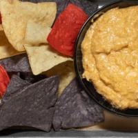 Smoked Chicken Wing Dip · Spicy three-cheese dip with hot sauce, smoked, pulled chicken.