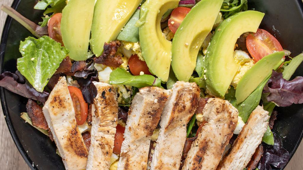 Cobb Salad · Grilled chicken, avocado, house-cured bacon, crumbled egg, tomato, a blend of iceberg lettuce, romaine, spring mix, house dressing or house-made bleu cheese.