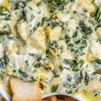 Artichoke Dip · Spinach, roasted garlic, Parmesan cheese and crostini.