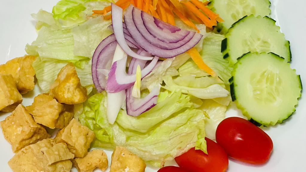Ginger Salad · Lettuce, red onions, tomatoes, cucumber, fried tofu and carrots with honey ginger dressing.