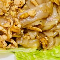 Pad Kua Gai · Stir-fried flat rice noodles, scallions, garlic and egg in a sesame brown sauce.