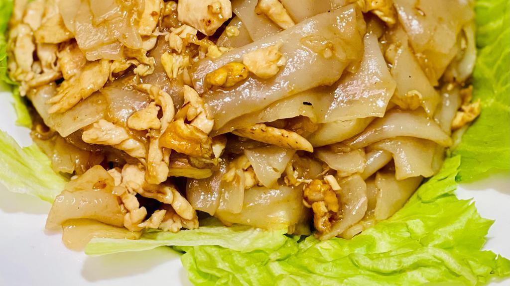 Pad Kua Gai · Stir-fried flat rice noodles, scallions, garlic and egg in a sesame brown sauce.