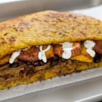 Cachapa Pabellon · Shredded beef, black beans, sweet yellow plantains, queso, and nata (housemade sour cream).