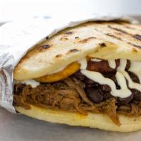 Pabellon Arepa · Cornmeal patty stuffed with shredded beef, black beans,  fried sweet plantains, queso blanco...