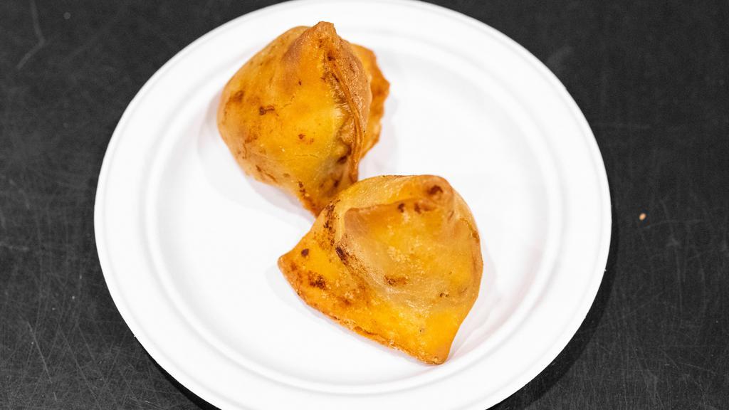 Vegetable Samosa · Crispy turnover with potatoes and a green pea filling.