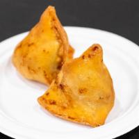 Meat Samosa · Crispy turnover with ground chicken and green pea filling.