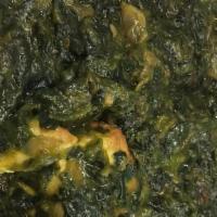 Palak Paneer  · Homestyle cheese simmered in freshly pureed spinach lightly spiced.