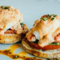 Classic Eggs Benedict · Poached eggs, Canadian bacon, hollandaise sauce on an English muffin served with home fries.