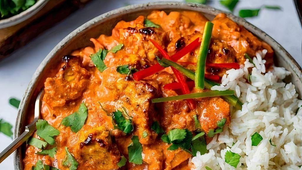 Chicken Tikka Masala · Boneless Chicken Tikka with onions and bell peppers cooked in classic tomato sauce. Served with a side of basmati rice.