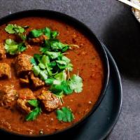 Lamb Vindaloo · Lamb chunks cooked with tangy spicy tomato sauce and potatoes. Served with a side of basmati...