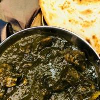 Chicken Saag · Chicken cooked in rich spinach gravy with spices. Served with a side of basmati rice.