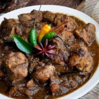 Chicken Chettinad · Spicy chicken curry cooked with star anise, curry leaves and coconut. Served with a side of ...