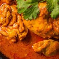 Chicken Vindaloo · Chicken chunks and potatoes cooked in tangy spicy tomato sauce. Served with a side of basmat...
