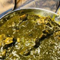 Goat Saag · Tender goat cooked in creamy spinach sauce. Served with a side of basmati rice.