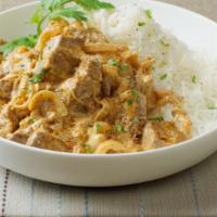Goat Korma · Tender goat simmered in rich creamy cashew sauce. Served with a side of basmati rice.