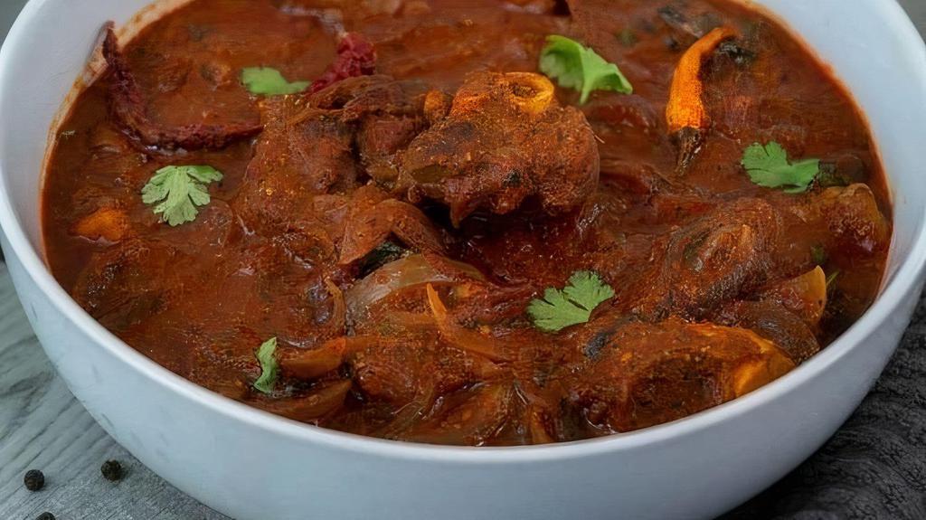 Goat Vindaloo · Tender goat cooked with tangy spicy tomato sauce and potatoes. Served with a side of basmati rice.