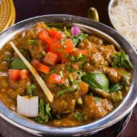 Kadai Goat · Tender goat chunks cooked with capsicum flavored tomato gravy. Served with a side of basmati...