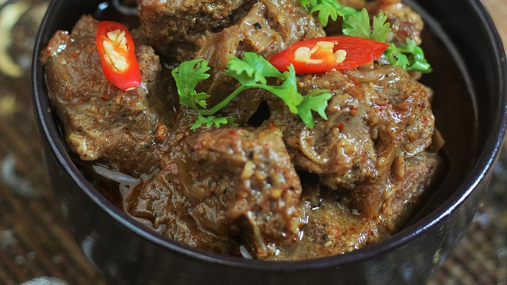 Lamb Chettinad · Spicy lamb curry made of star anise, curry leaves and coconut. Served with a side of basmati rice.