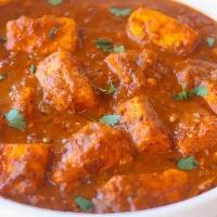 Paneer Vindaloo · Paneer chunks and potatoes cooked in tangy spicy tomato sauce. Served with a side of basmati...