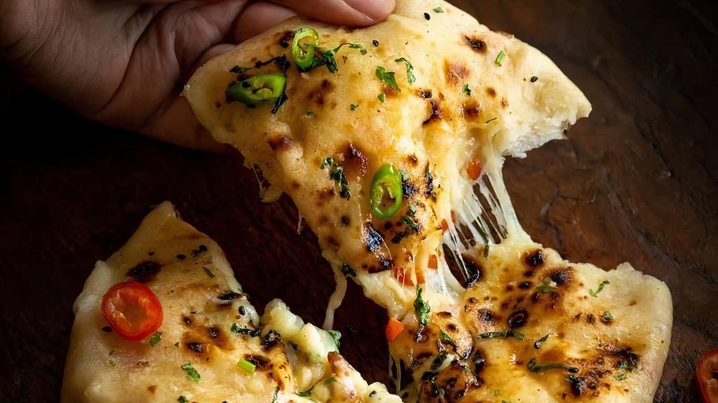 Cheese Naan · Special leavened tandoor baked flat bread topped with cheese.