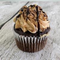 Chocolate Peanut Buttery Cupcake · Chocolate cupcake filled with homemade peanut butter frosting and topped with crumbled peanu...