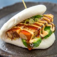 Kakuni Bun · Braised pork with mixed greens, cucumber, scallions, and spicy mayo BBQ sauce in a steamed b...