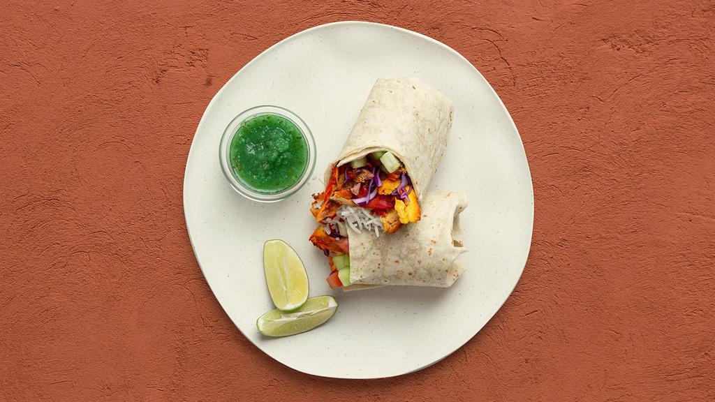 Tandoori Chicken Burrito · Flavorful tandoori chicken with basmati rice, diced cucumber and tomato, shredded cabbage, and mint chutney in a naan wrap.