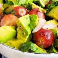 Avocado Salad · Sliced avocado on the bed of tomatoes and onions served with olive oil.
