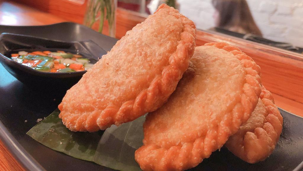 Curry Puffs · Siamese pastry stuffed with chicken, potatoes and curry.