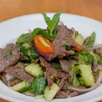 Beef Salad · Seared beef, rice powder, red onion, scallion, cilantro, mint leaves and chili lime.