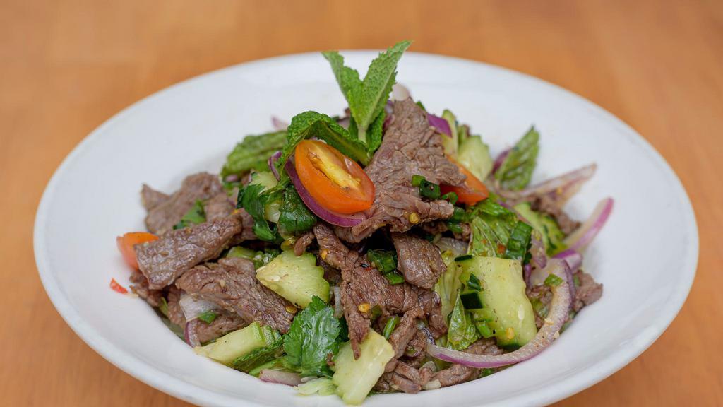 Beef Salad · Seared beef, rice powder, red onion, scallion, cilantro, mint leaves and chili lime.