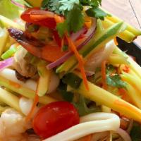 Seafood Mango Salad · Shrimp, squid, mussels, shredded mango, scallion, onion, carrot served with bird chilies, ga...
