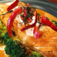 Chu Chee Salmon · Grilled salmon with chu chee sauce, kaffir lime leaves, red bell pepper and steamed broccoli.