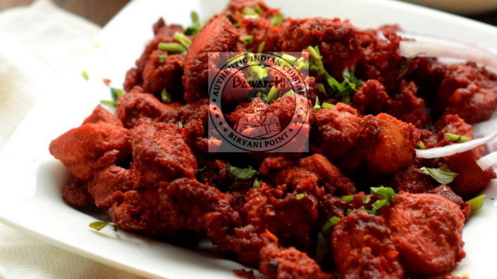 Chicken 65 · Boneless fried chicken tempered with chilies and spices.